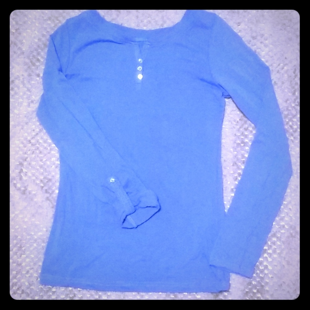 3 button blouse available in blue, pink, and red.